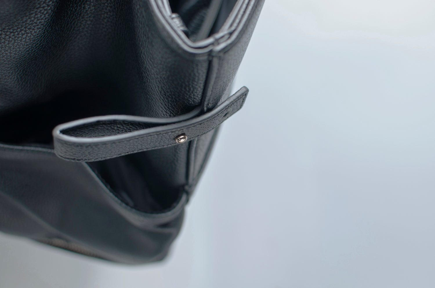 Detailed view of the elegant craftsmanship on an After Story leather handbag, emphasizing the polished hardware and fine leather grain.